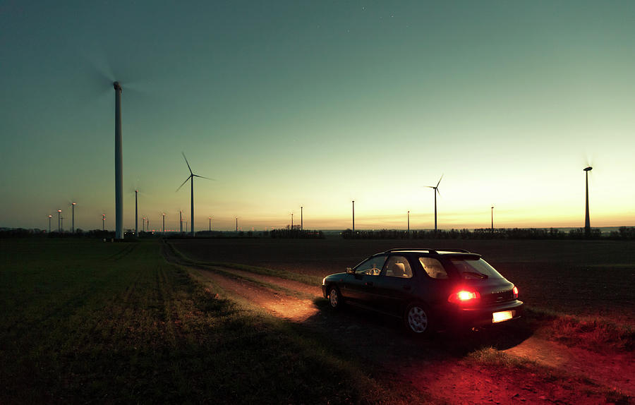 Car Passing From Wind Turbines Field Photograph by Spreephoto.de