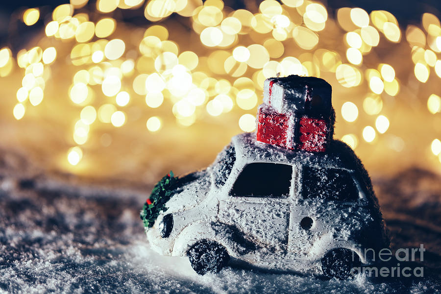 Car with Christmas gifts on the roof on snowy road Photograph by Michal Bednarek