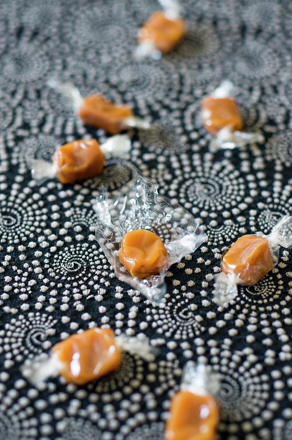 Caramel Bonbons Wrapped In Cellophane Photograph by Anthony Lanneretonne