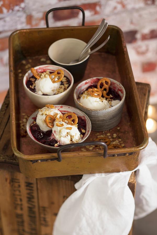 Caramel Ice Cream With Cherry Compote And Salty Pretzel-shaped Biscuits Photograph by Eising Studio