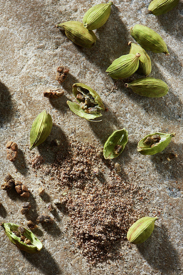 Cardamom Pods With Ground Cardamom On Stone From Overhead Photograph by Flashlight Studio