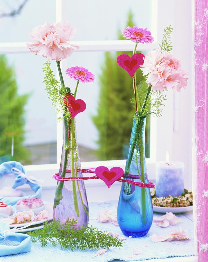 Carnations, Gerbera & Ornamental Asparagus In Glass Vases Photograph by Friedrich Strauss