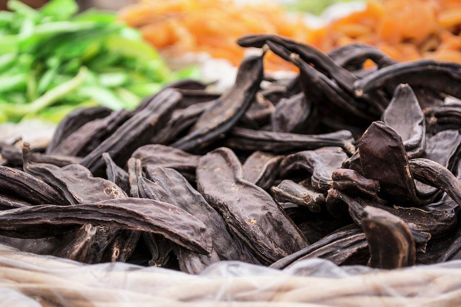 Carob Pods In A Basket At A Market Stall Photograph by Marya Cerrone