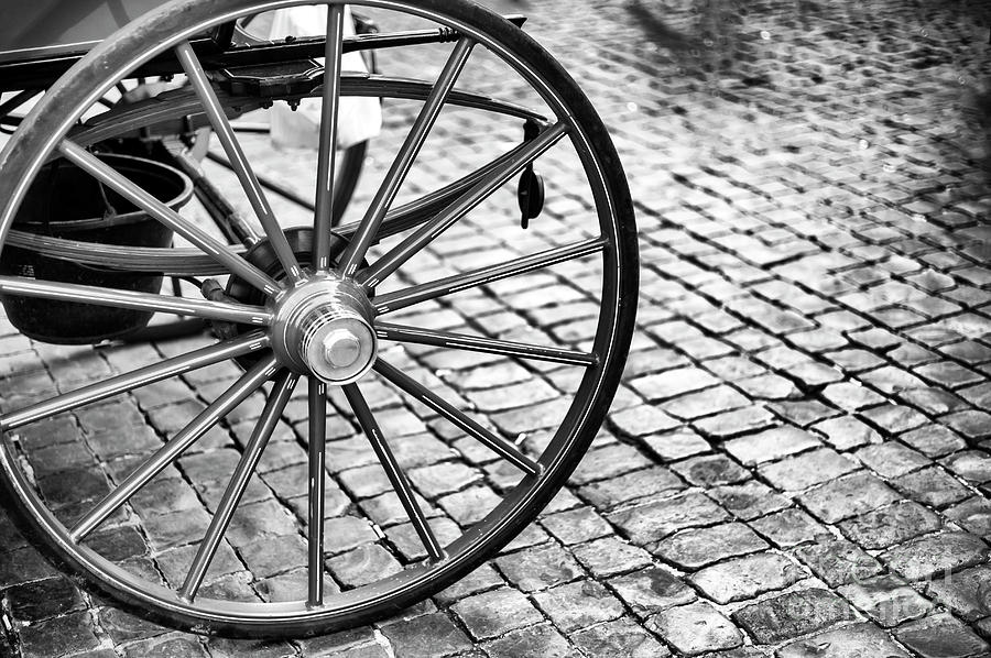 Carriage Wheel at Piazza Navona in Roma Photograph by John Rizzuto