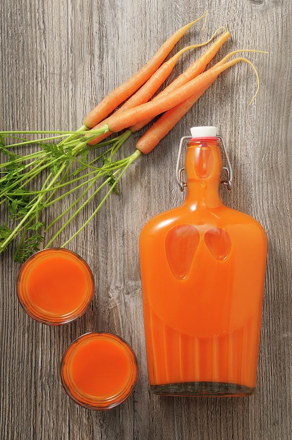 Carrot Juice In Glasses And A Flip-top Bottle seen From Above Photograph by Jean-christophe Riou