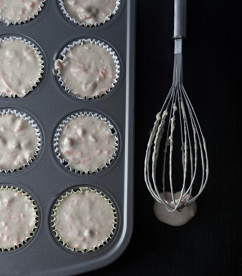 Carrot Muffin Mixture In A Muffing Tin With A Whisk Next To It Photograph by Vfoodphotography