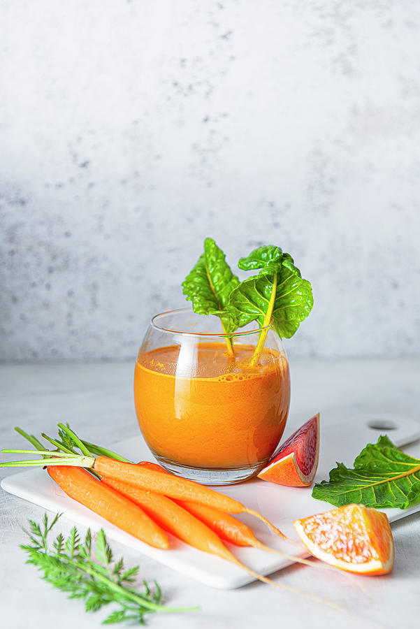 Carrot, Orange And Grapefruit Juice With Rainbow Chard Photograph by Magdalena Hendey Gough
