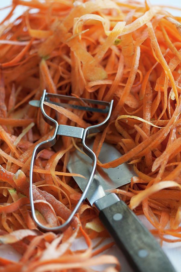 Carrot Peelings, A Peeler And A Knife Photograph by Martina Schindler