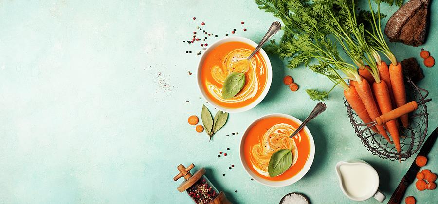 Carrot Soup In White Bowls On Blue Background Photograph by Natalia Klenova
