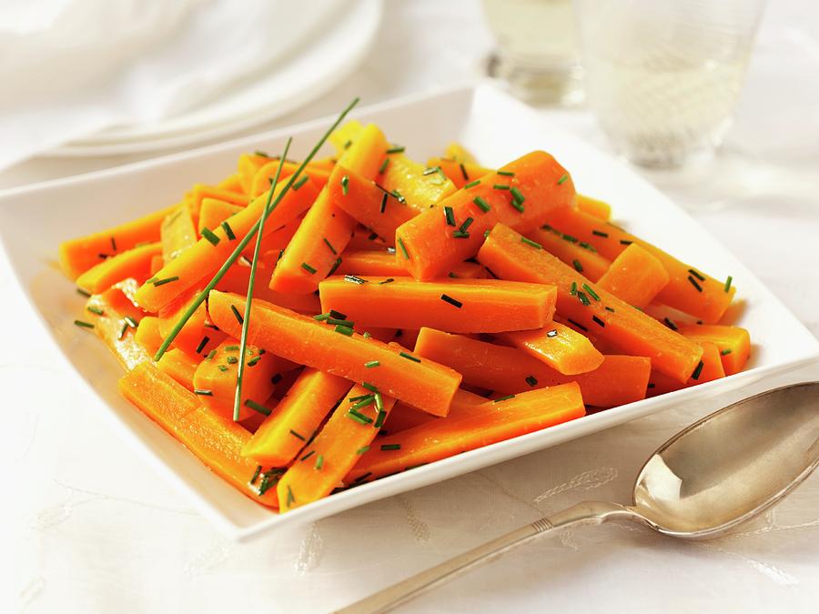 Carrots With Butter And Chives With A Spoon Photograph by Frank Adam