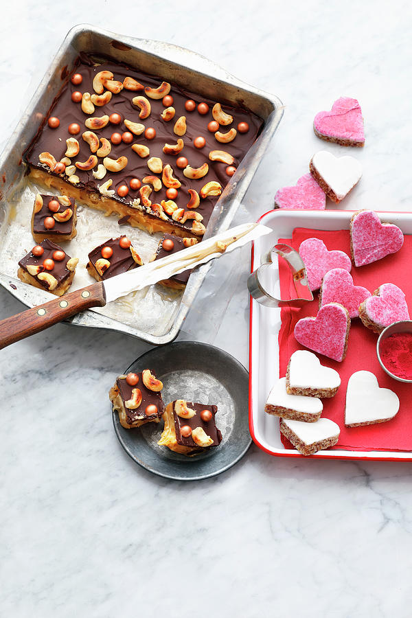 Cashew Caramel Confectionery And Almond Hearts With Cassis Icing Photograph by Mathias Stockfood Studios / Neubauer