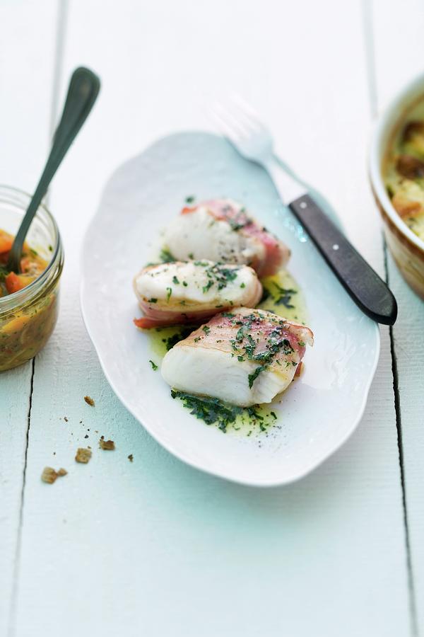 Cat Fish Fillet Wrapped In Bacon With Herbs Photograph by Michael Wissing