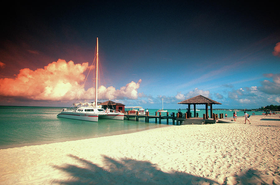 Catamaran Docked At Pier At Sunset On Photograph by Medioimages/photodisc Catamaran Docked At Pier At Sunset On Photograph by Medioimages/photodisc