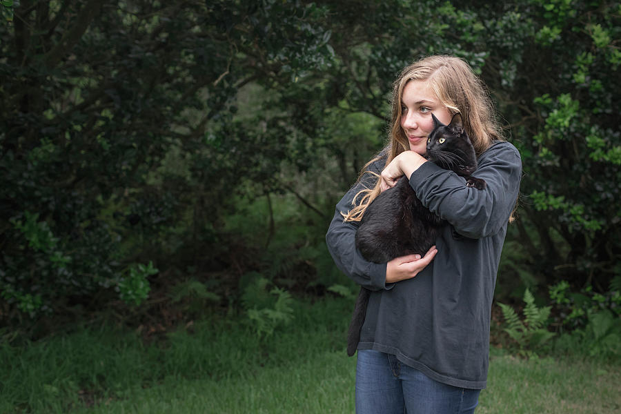 Orlando Photograph - Caucasian Girl With Long Blond Hair Holds Black Cat Outside by Cavan Images