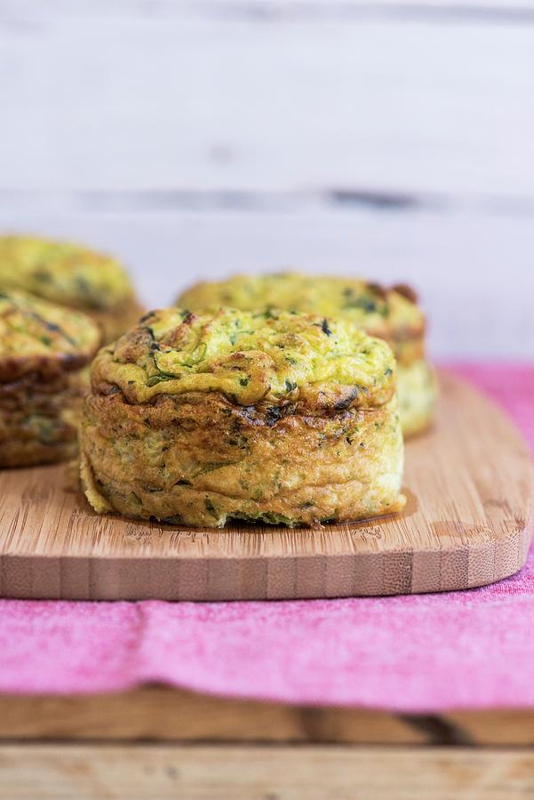 Cauliflower And Courgette Cakes On A Wooden Board Photograph by Hein Van Tonder
