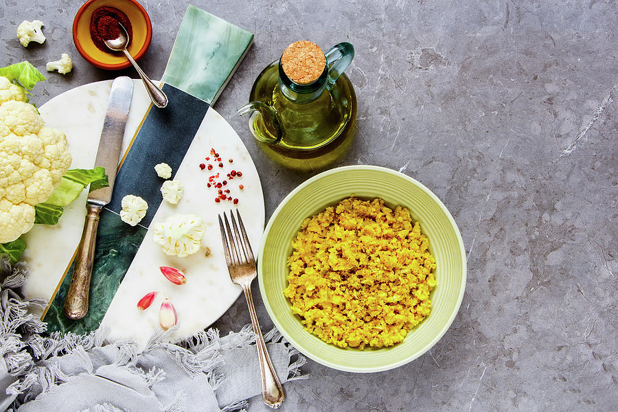 Cauliflower Rice With Spices In Bowl And Raw Cauliflower Photograph by Yuliya Gontar