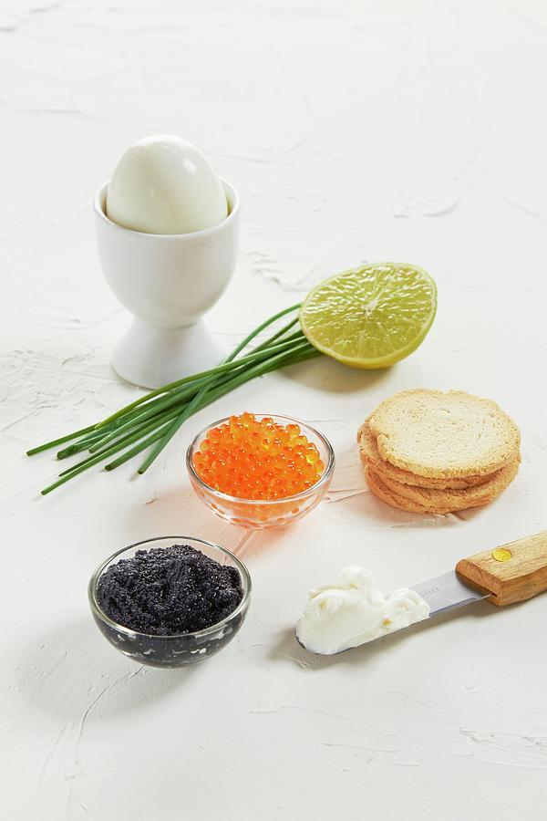 Caviar, A Boiled Egg, Chives, Lime, Crackers And Cream Cheese Photograph by Miriam Rapado