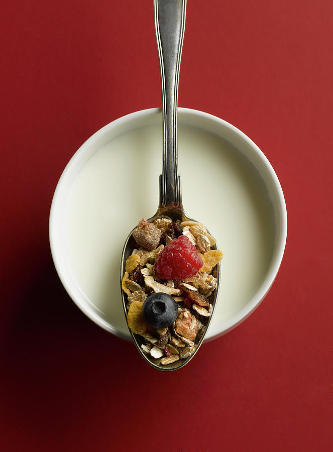 Cereal And Fruits In Spoon On Bowl Of Photograph by Westend61
