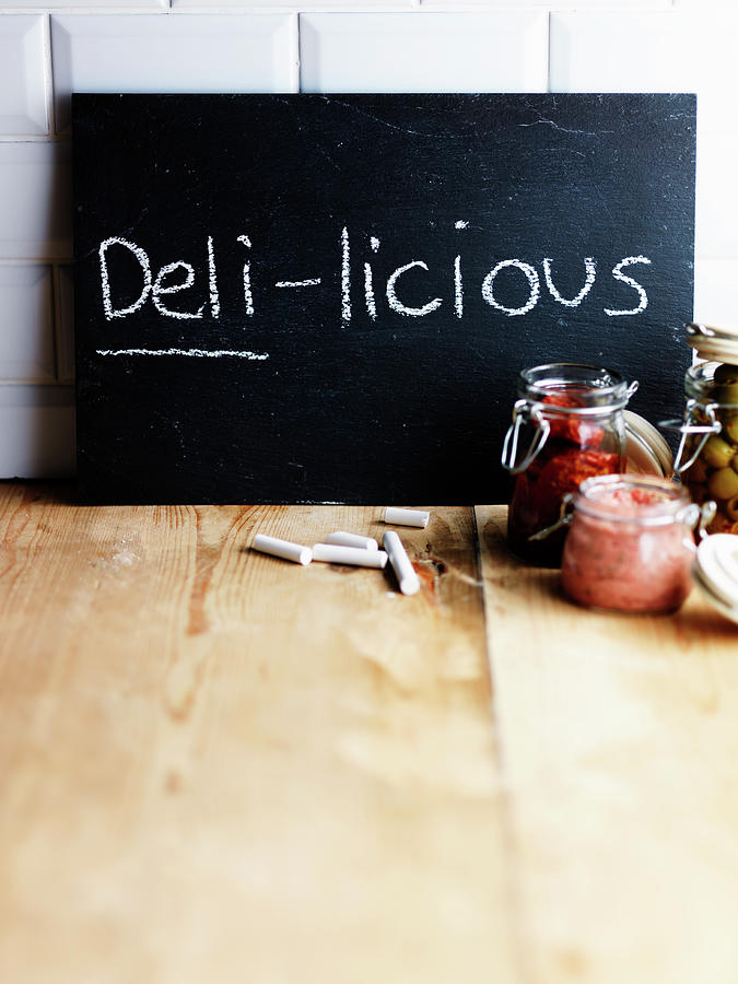 Chalkboard With Handwritten deli-licious And Various Preserving Jars Photograph by Karen Thomas