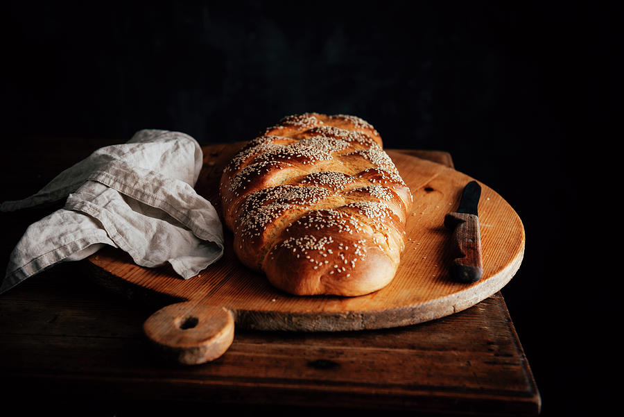 Challah Bread With Sesame Seeds On A Rustic Wooden Board Photograph by Justina Ramanauskiene