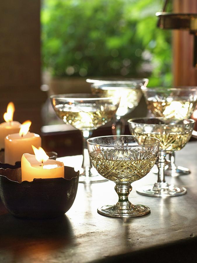 Champagne In Crystal Goblets Next To Burning Candles Photograph by Great Stock!