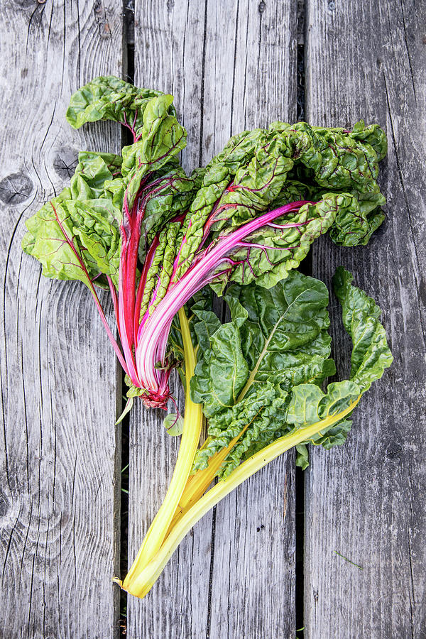 Chard On A Wooden Surface Photograph by Claudia Timmann