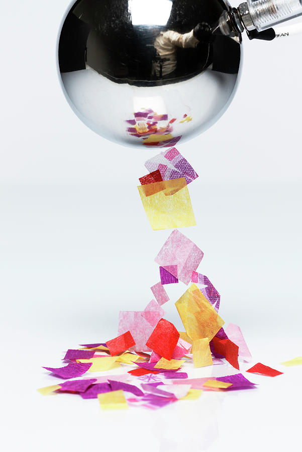 Charged Ball Attracts Paper Bits Photograph by GIPhotoStock Images