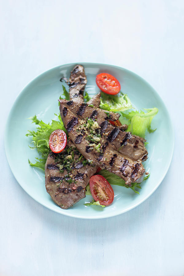 Chargrilled Lamb Liver Slices On Salad Greens And Grilled Plum Tomatoes Photograph by Zappie