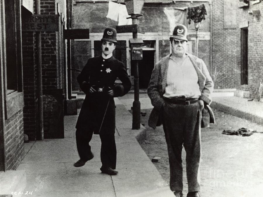 Charlie Chaplin Left In Police Uniform Photograph by Bettmann