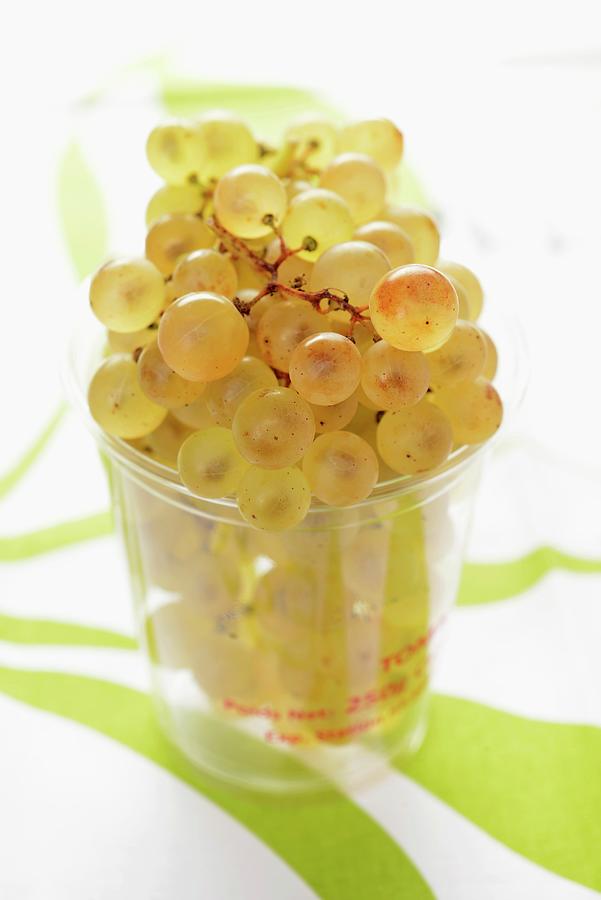 Chasselas Grapes In A Plastic Tumbler Photograph by Alain Caste