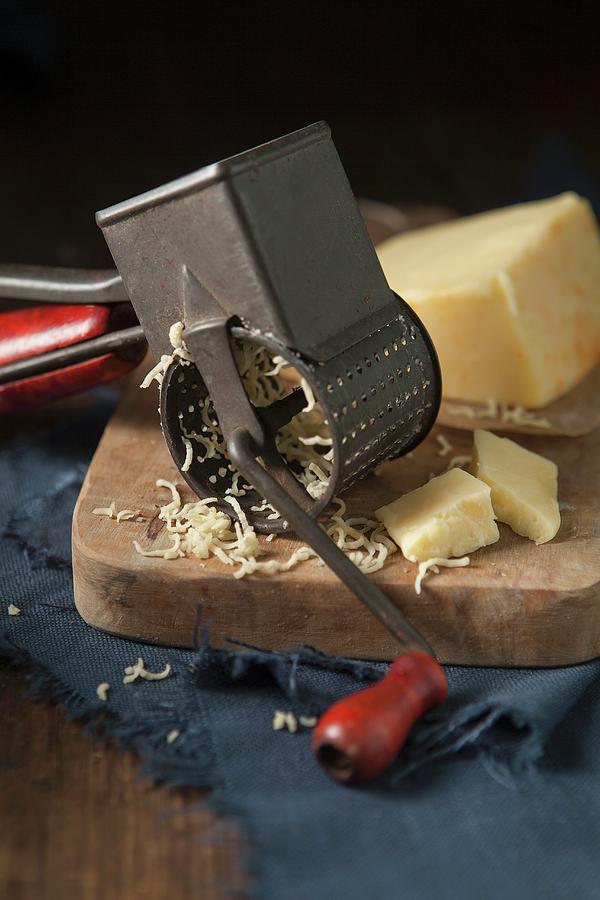 Cheddar Cheese Being Grated By A Vintage Rotary Cheese Grater Photograph by Stacy Grant