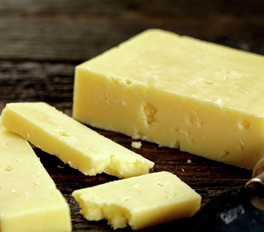 Cheddar Cheese On Dark Wood Photograph by Robert Morris