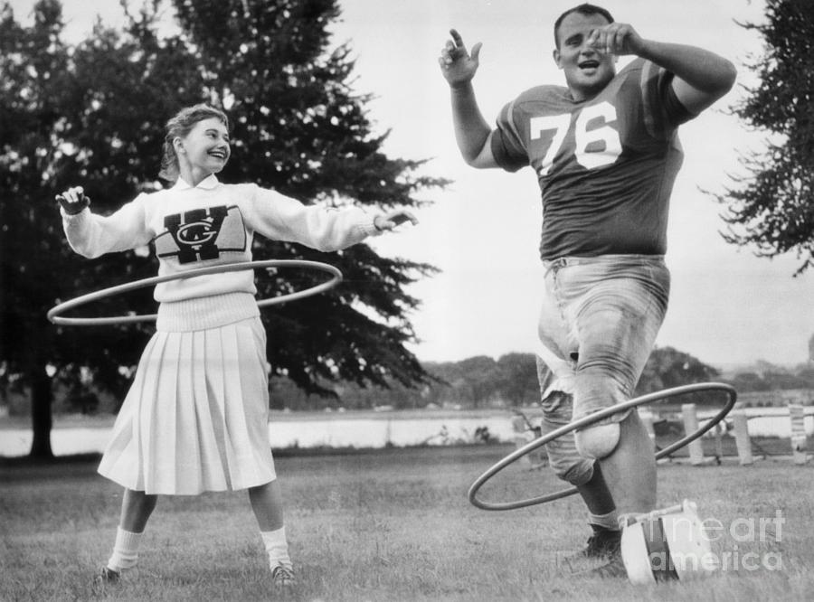 Cheerleader And Ed Rurbach Hula Hooping Photograph by Bettmann