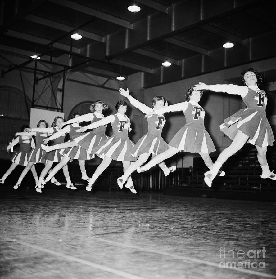 Cheerleaders Jumping In The Air Photograph by Bettmann