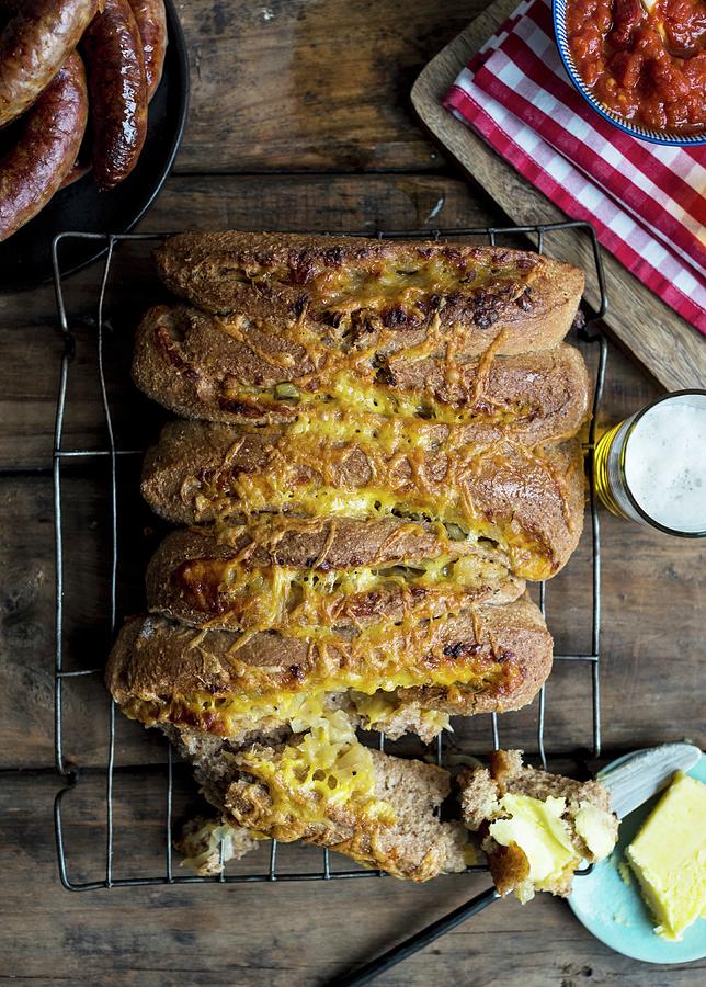 Cheese And Onion Bread On A Cooling Rack Photograph by Hein Van Tonder