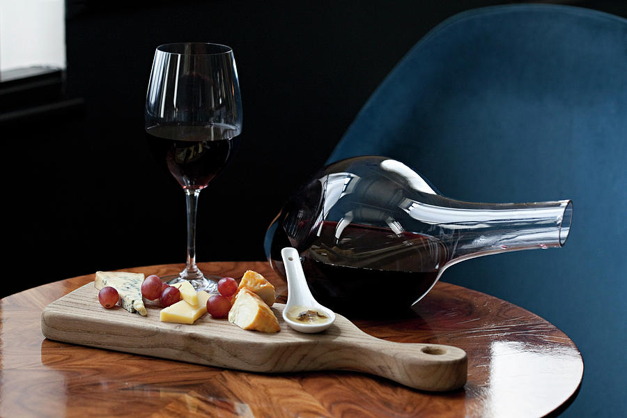 Cheese Board On A Table With A Glass Of Red And A Wine Decanter Photograph by Steven Joyce