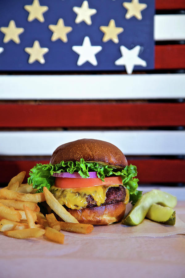 Cheese Burger With Lettuce Tomato, Onion, Pickle And French Fries With American Flag Photograph by Andre Baranowski