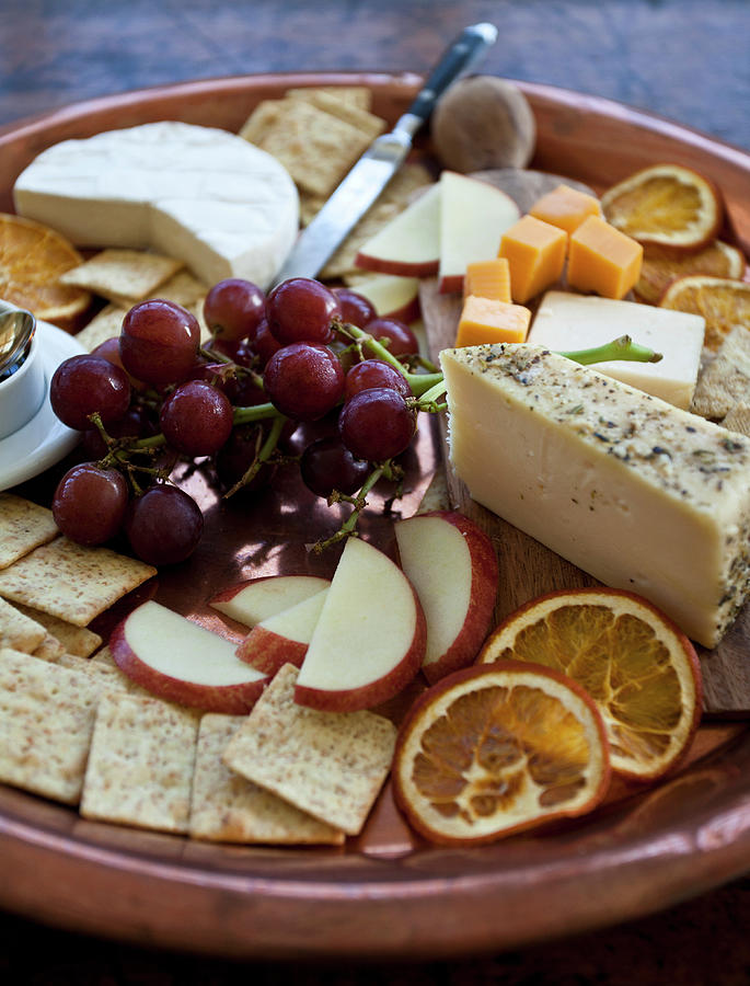 Cheeseboard On A Copper Tray With Brie, Cheddar And Herbed Cheese ...