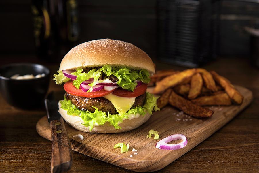 Cheeseburger With Tomatoes, Onion And Lettuce Photograph by Magdalena Hendey