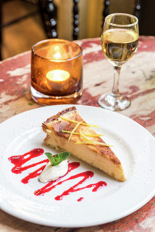Cheesecake Decorated With Lemon Zest And Ice Cream On A Wooden Table Photograph by Giulia Verdinelli Photography