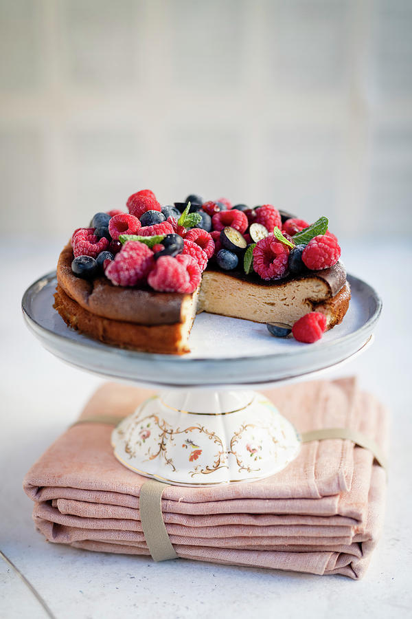 Cheesecake With Berries On A Cake Stand, Sliced Photograph by Lucy Parissi