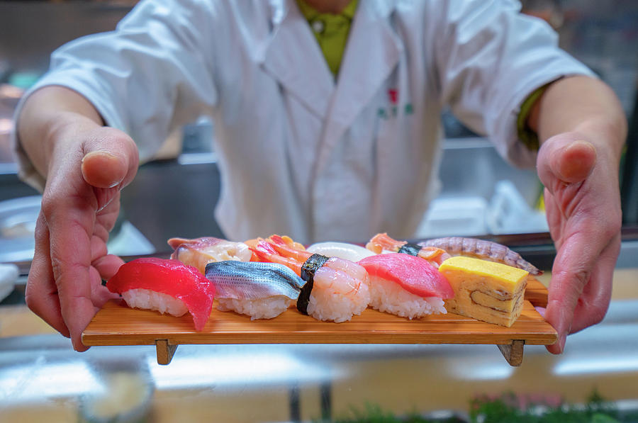 Chef served Japanese Sushi on wooded plate by hand Photograph by Anek Suwannaphoom