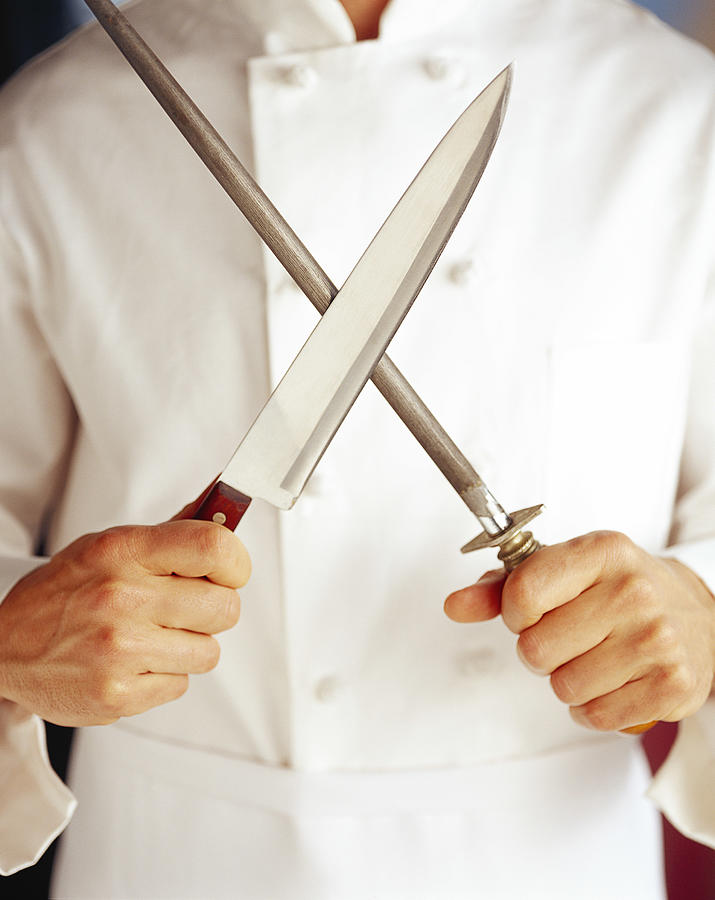 Chef Sharpening Knife Photograph by Brand X Pictures
