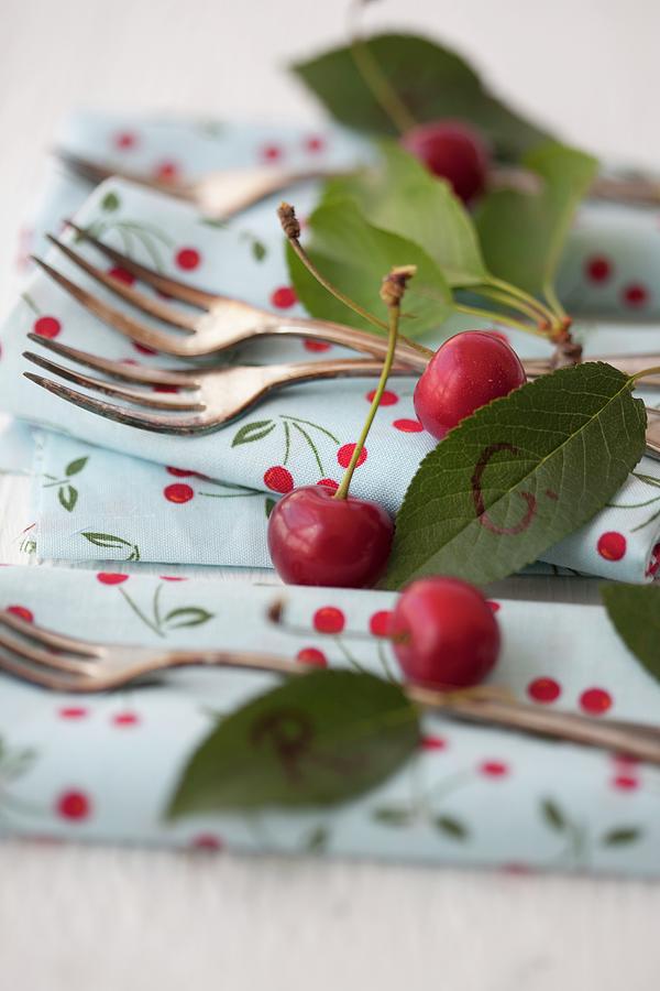 Cherries, Napkins And Cake Forks Photograph by Martina Schindler