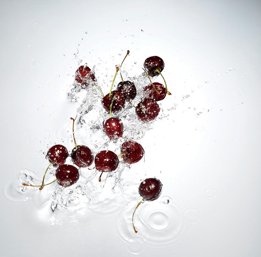 Cherries Splashing In To Water Photograph by Chris Stein