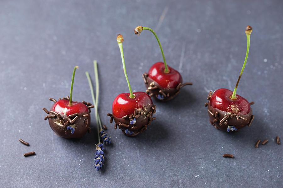 Cherries With Chocolate, Chocolate Sprinkles, Lavender Flowers And Gold Powder Photograph by Mandy Reschke