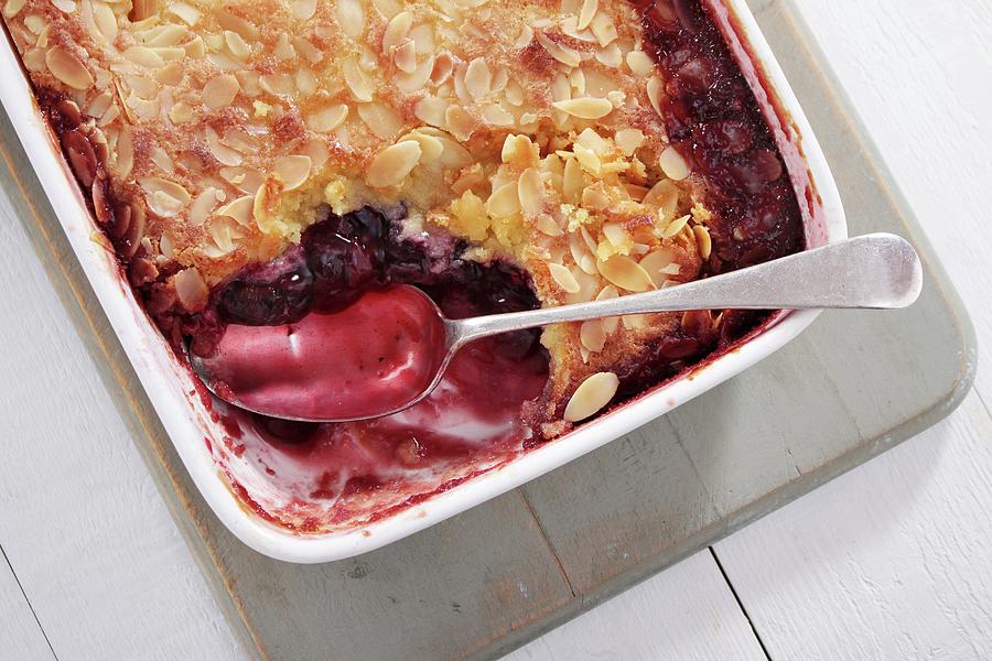 Cherry And Almond Pudding In A Baking Dish Photograph by Neil Langan