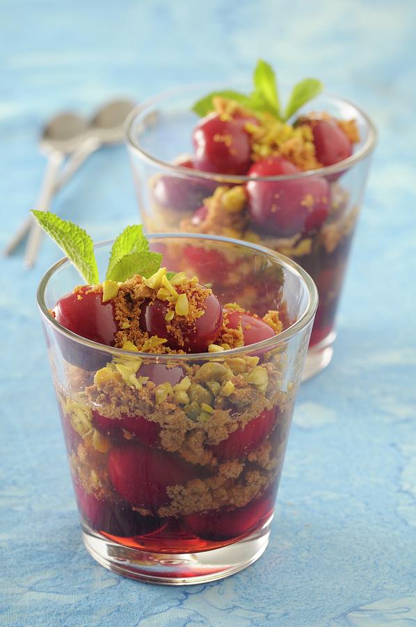 Cherry Desserts In Glasses With Almond Crumbs And Pistachios Photograph by Jean-christophe Riou