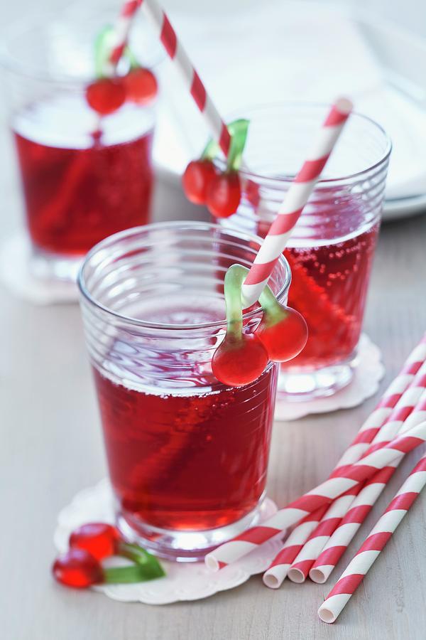 Cherry Juice Spritzer In Glasses With Straws Decorated With Cherry Jelly Sweets Photograph by Taube, Franziska