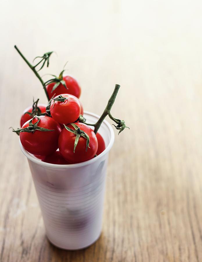 Cherry Tomatoes In A Plastic Glass Photograph by Vulman Pter